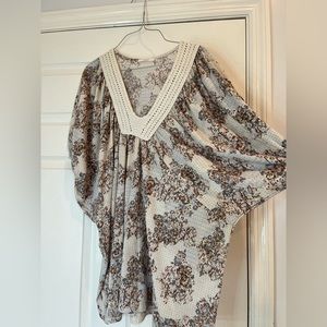 This top is a flowered short sleeve blouse and a v-neck